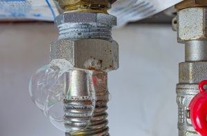 Gas leak at home heating boiler. Inflating bubbles of soap mixture.